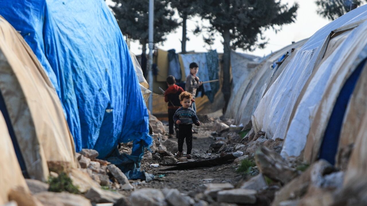 Internally displaced Syrians pictured in front of tents, before they became resident at a new housing complex in the opposition-held area of Bizaah, in the northern Aleppo governorate