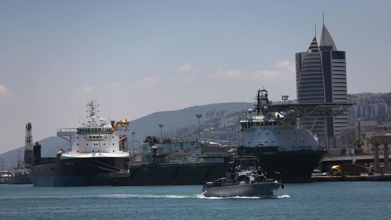 Cargo ships are moored along a dock at the port of Haifa, Israel, June 24, 2021.