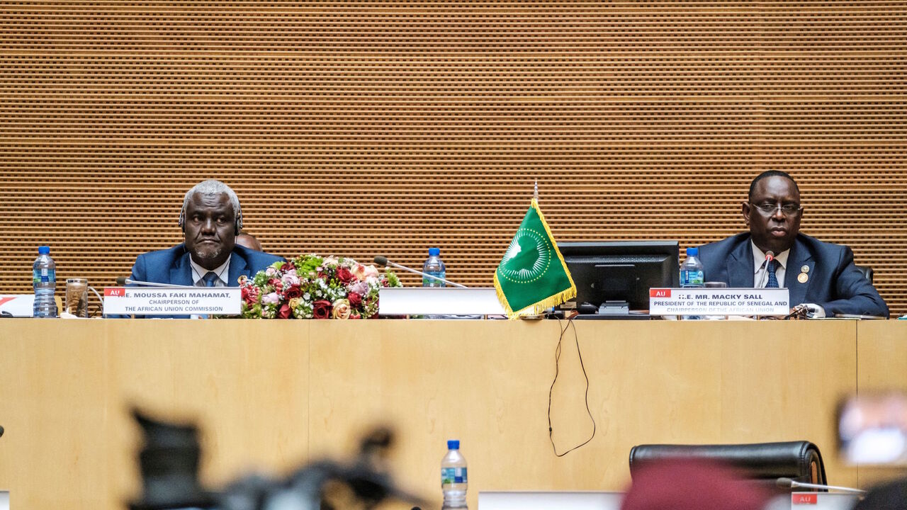 Moussa Faki Mahamat (L), African Union Commission (AUC) Chairperson, and Macky Sall (R), Senegal's President and Chairperson of the African Union, address the press during the closing session of the 35th ordinary summit of the organization, in the city of Addis Ababa, Ethiopia, on Feb. 6, 2022. 