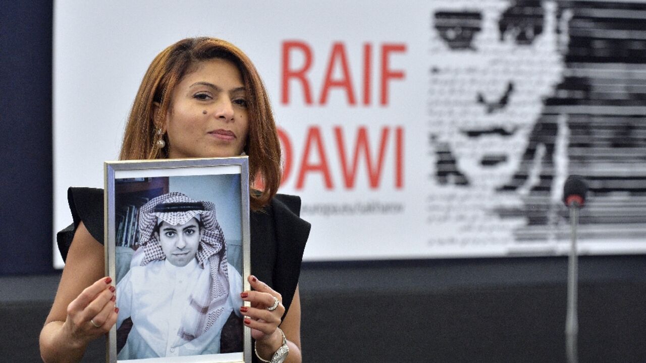 Ensaf Haidar holds a picture of her husband, Saudi blogger Raif Badawi, after accepting the European Parliament's Sakharov human rights prize on his behalf Ensaf Haidar holds a picture of her husband, Saudi blogger Raif Badawi, after accepting the European Parliament's Sakharov human rights prize on his behalf
