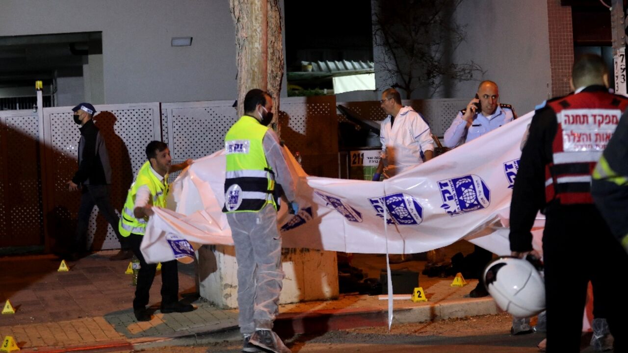 Israeli security forces gather at the site of an attack claimed by the Islamic State jihadist group that left two Israeli police dead in the northern city of Hadera on March 27