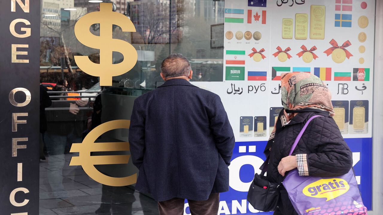 People look at exchange rates outside an exchange office, Ankara, Turkey, Feb. 23, 2022.