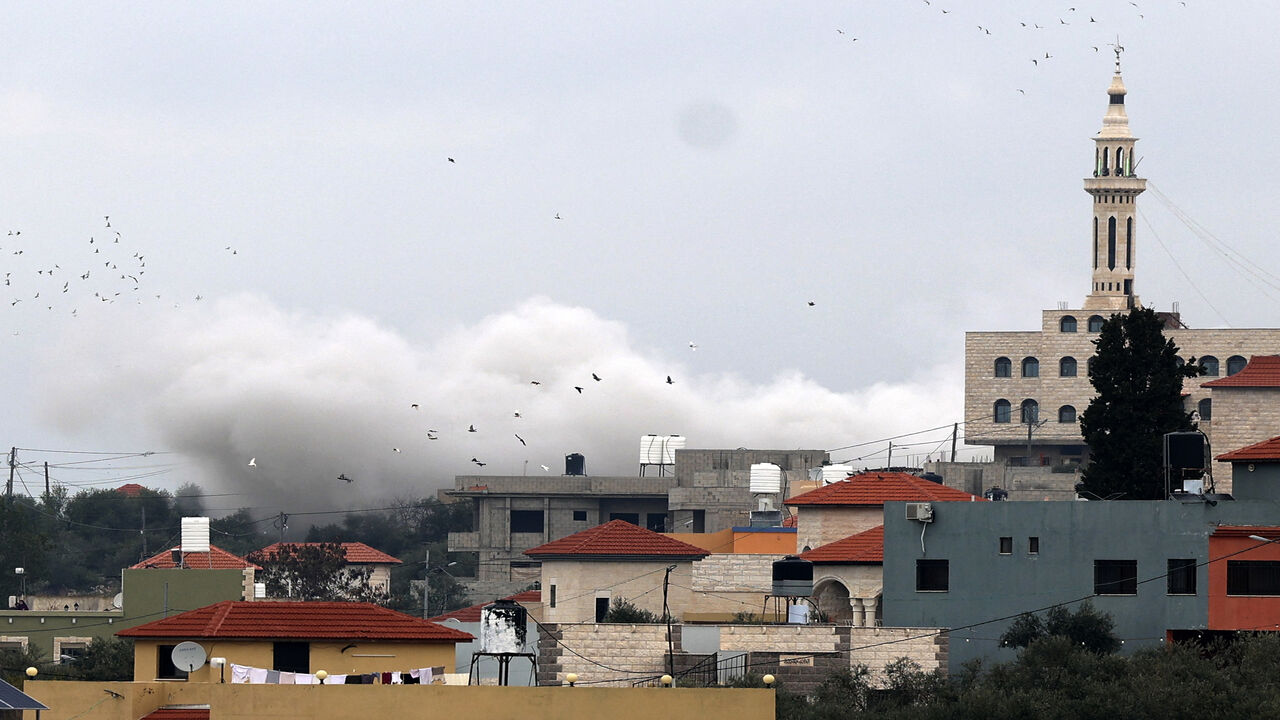 Smoke billows from the house of a Palestinian suspect after it was demolished by Israeli security forces, in the village of Silat al-Harithiya near the flashpoint town of Jenin, West Bank, March 8, 2022.