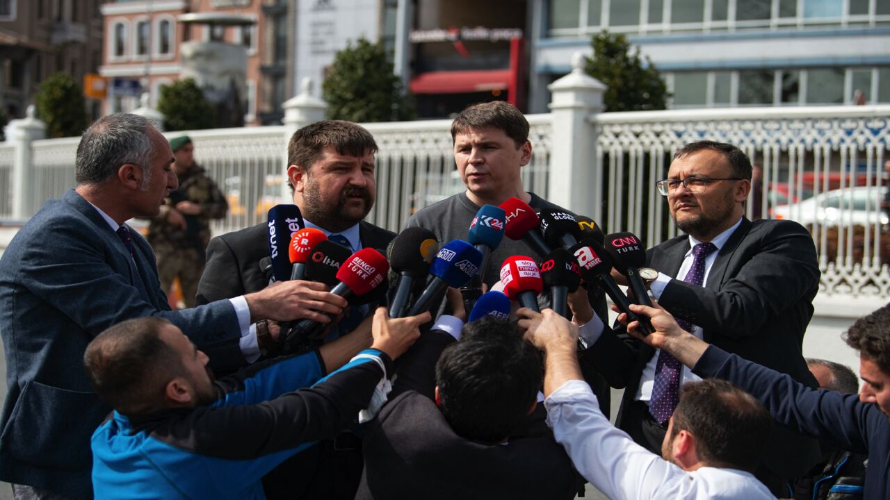 Ukrainian presidential adviser Mykhailo Podolyak (C) speaks to the press.