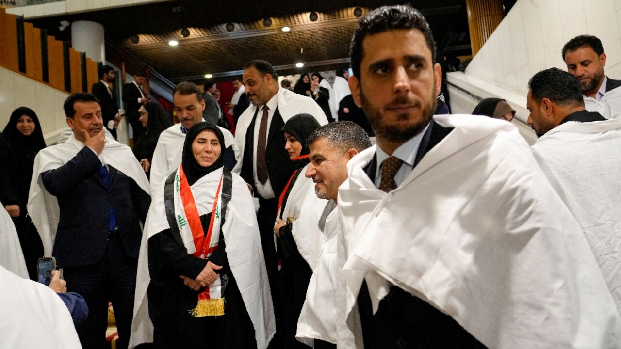 Iraqi MPs from the Sadrist bloc of Shiite leader Moqtada Sadr gather inside the Iraqi parliament in Baghdad ahead of a vote to elect a new president for the country. The election was postponed due to a lack of quorum for the second time since February