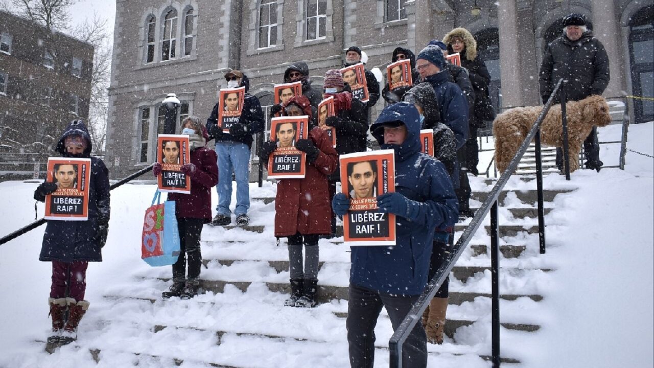 Saudi blogger Raif Badawi, seen on pictures held by supporters at a February 2022 vigil in Montreal, has been released after serving a 10-year sentence in Saudi Arabia Saudi blogger Raif Badawi, seen on pictures held by supporters at a February 2022 vigil in Montreal, has been released after serving a 10-year sentence in Saudi Arabia
