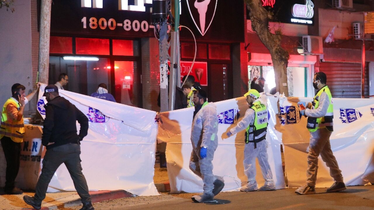 Israeli security forces gather at the site of an attack that left two Israeli police dead in the northern city of Hadera