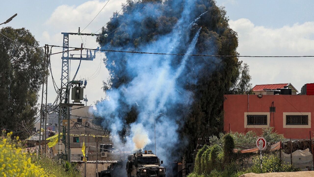 Tear gas canisters are fired from an Israeli military vehicle near the Palestinian refugee camp of Jenin in the occupied West Bank on April 9, 2022 Tear gas canisters are fired from an Israeli military vehicle near the Palestinian refugee camp of Jenin in the occupied West Bank on April 9, 2022
