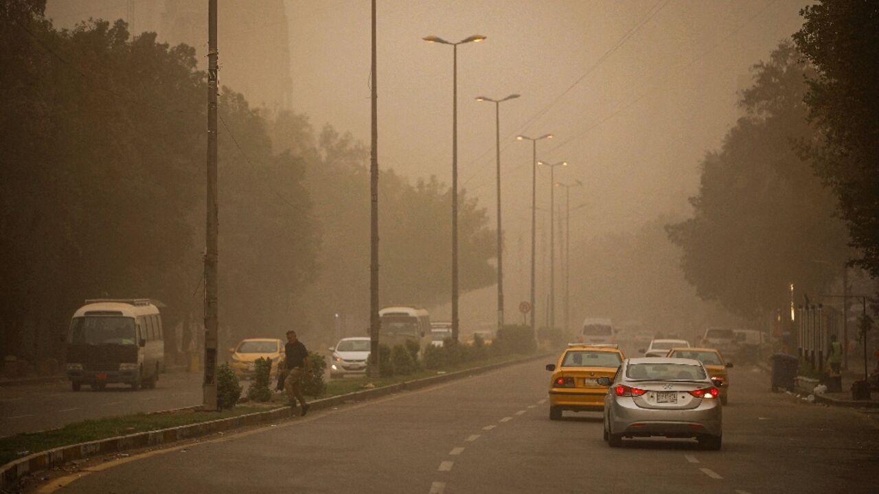 Vehicles drive through Baghdad under reduced visibility during a dust storm that engulfed much of central Iraq, the second such storm in a week