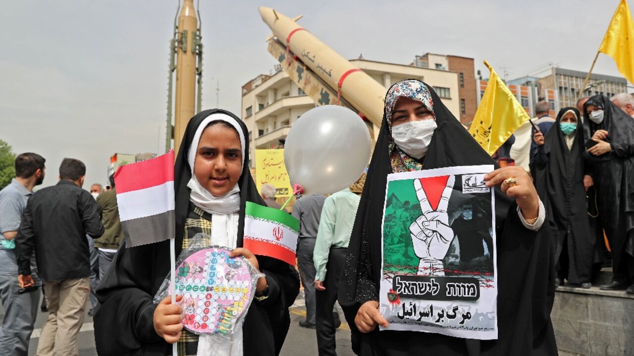 Iranian girls hold a sign reading in Hebrew and Persian, "Death to Israel" during the annual Quds (Jerusalem) Day rally in Tehran in support of the Palestinian people Iranian girls hold a sign reading in Hebrew and Persian, "Death to Israel" during the annual Quds (Jerusalem) Day rally in Tehran in support of the Palestinian people