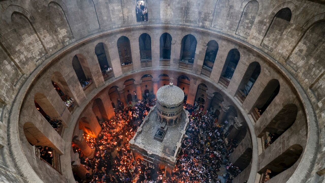 Orthodox Christians gather with lit candles around the Edicule, traditionally believed to be the burial site of Jesus Christ, during the Holy Fire ceremony at Jerusalem's Holy Sepulchre church Orthodox Christians gather with lit candles around the Edicule, traditionally believed to be the burial site of Jesus Christ, during the Holy Fire ceremony at Jerusalem's Holy Sepulchre church