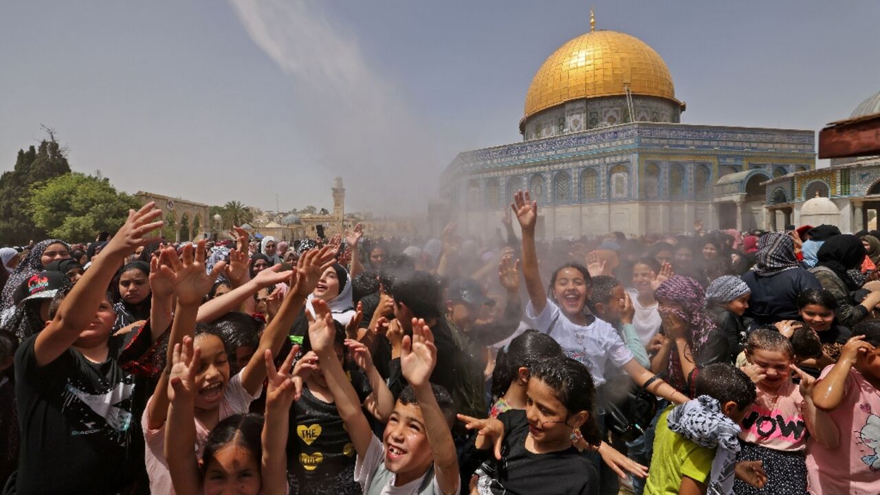Palestinian worshippers attend the last Friday prayers of the Muslim holy fasting month of Ramadan, outside the Dome of the Rock mosque at the Al-Aqsa mosque compound in Israeli-annexed east Jerusalem Palestinian worshippers attend the last Friday prayers of the Muslim holy fasting month of Ramadan, outside the Dome of the Rock mosque at the Al-Aqsa mosque compound in Israeli-annexed east Jerusalem