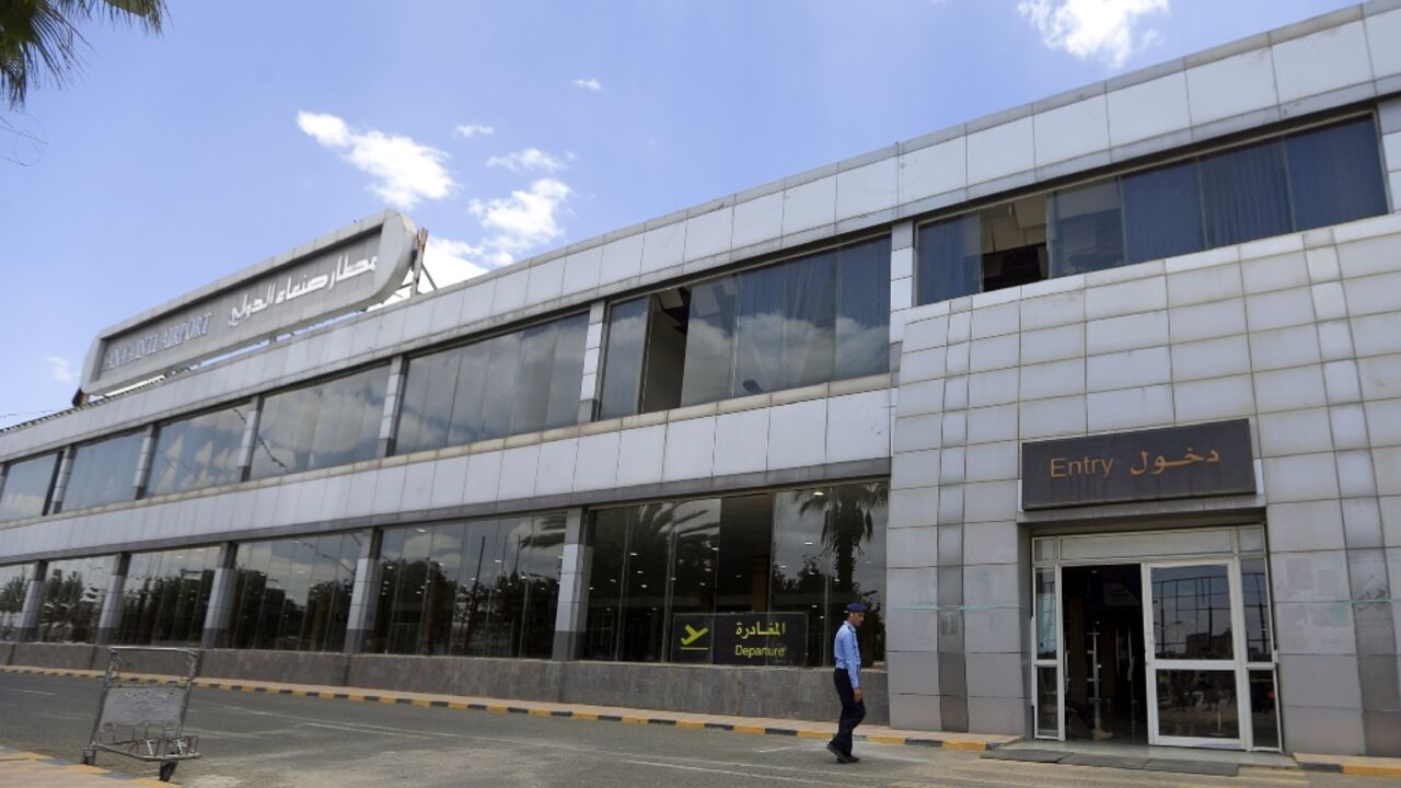 A member of security walks outside the  Sanaa International Airport departure hall after the first commercial flight out of Yemen's rebel-held capital in six years was indefinitely postponed