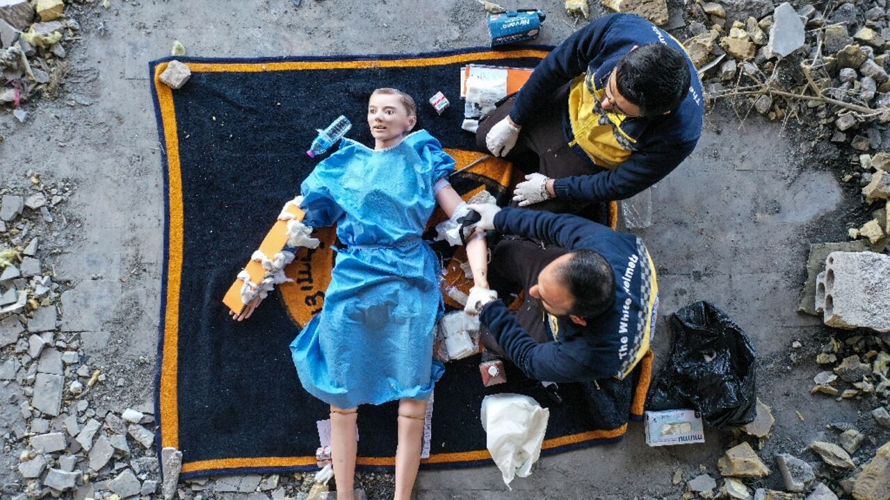 Members of the Syrian White Helmets use a dummy to demonstrate rescue skills in an instructive film intended for Ukrainians Members of the Syrian White Helmets use a dummy to demonstrate rescue skills in an instructive film intended for Ukrainians