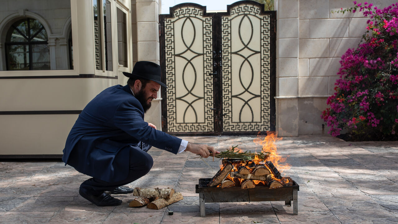 Adhering to Jewish tradition, Rabbi Levi Duchman burns willow branches.