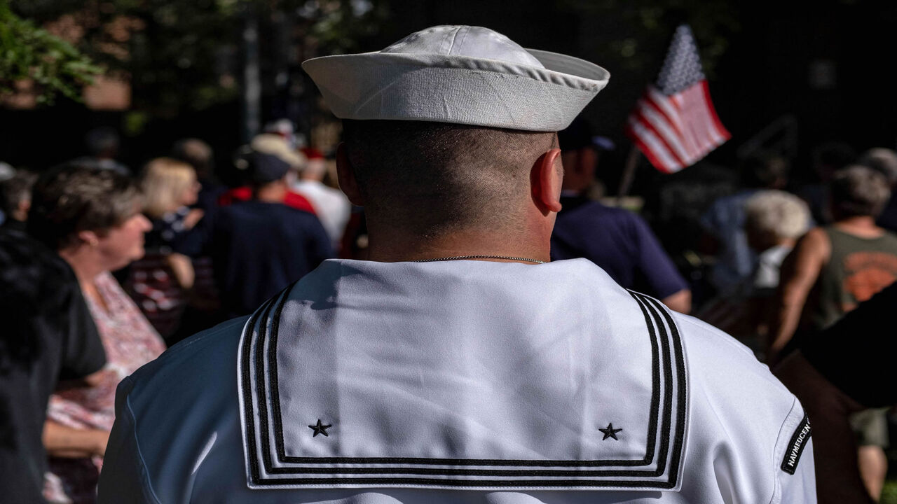 A US Navy service member attends a vigil for Navy Corpsman Maxton "Max" W. Soviak at Edison Middle School in Berlin Heights, Ohio, Aug. 29, 2021. Soviak was killed during the Aug. 26 terrorist attack outside of Kabul Airport in Afghanistan along with 12 other American service members and more than 100 Afghans.