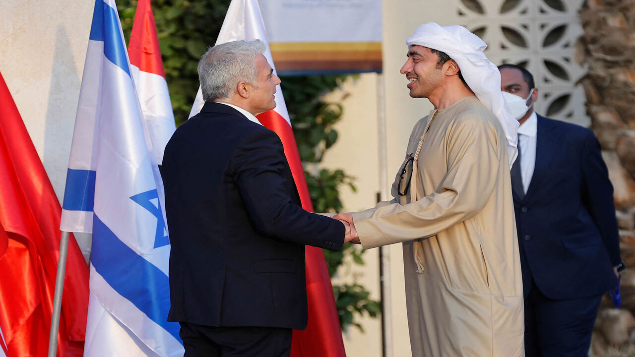 Israeli Foreign Minister Yair Lapid (L) welcomes the United Arab Emirates' Foreign Minister Sheikh Abdullah bin Zayed Al Nahyan upon his arrival for the Negev summit, at Sde Boker in the southern Negev desert, Israel, March 27, 2022.