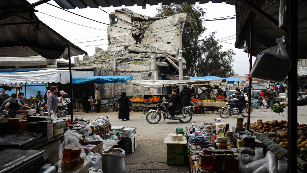 Syrians gather at a market as they prepare for the upcoming Muslim holy month of Ramadan, in the war-ravaged town of Ariha in the rebel-held northwestern Idlib province, Syria, March 31, 2022.