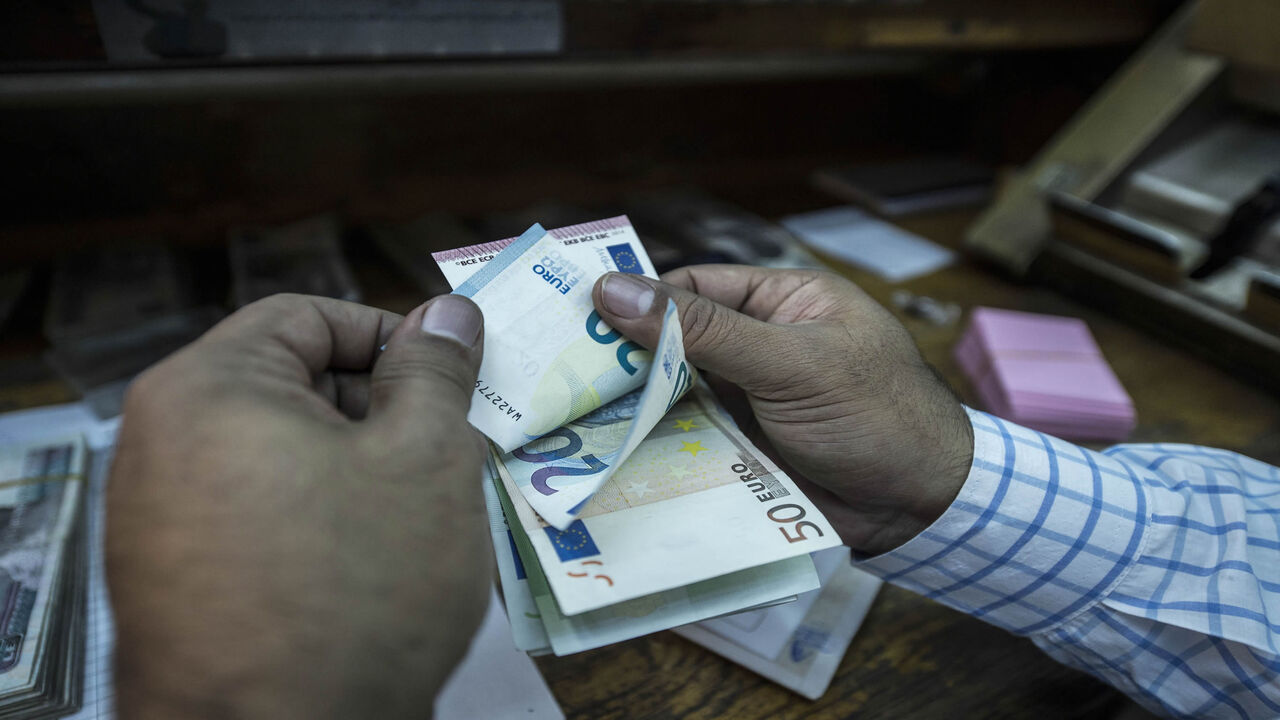 An employee counts banknotes at a currency exchange shop, Cairo, Egypt, Nov. 3, 2016.