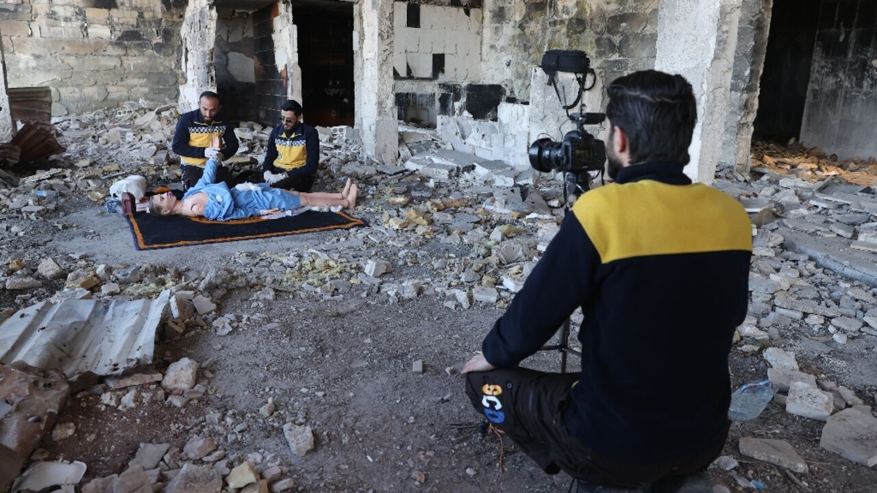 Members of the Syrian civil defence known as the White Helmets use a dummy to demonstrate their rescue skills during a video shoot for an instructive film intended for Ukrainian rescuers, in the war-ravaged Syrian town of Ariha Members of the Syrian civil defence known as the White Helmets use a dummy to demonstrate their rescue skills during a video shoot for an instructive film intended for Ukrainian rescuers, in the war-ravaged Syrian town of Ariha