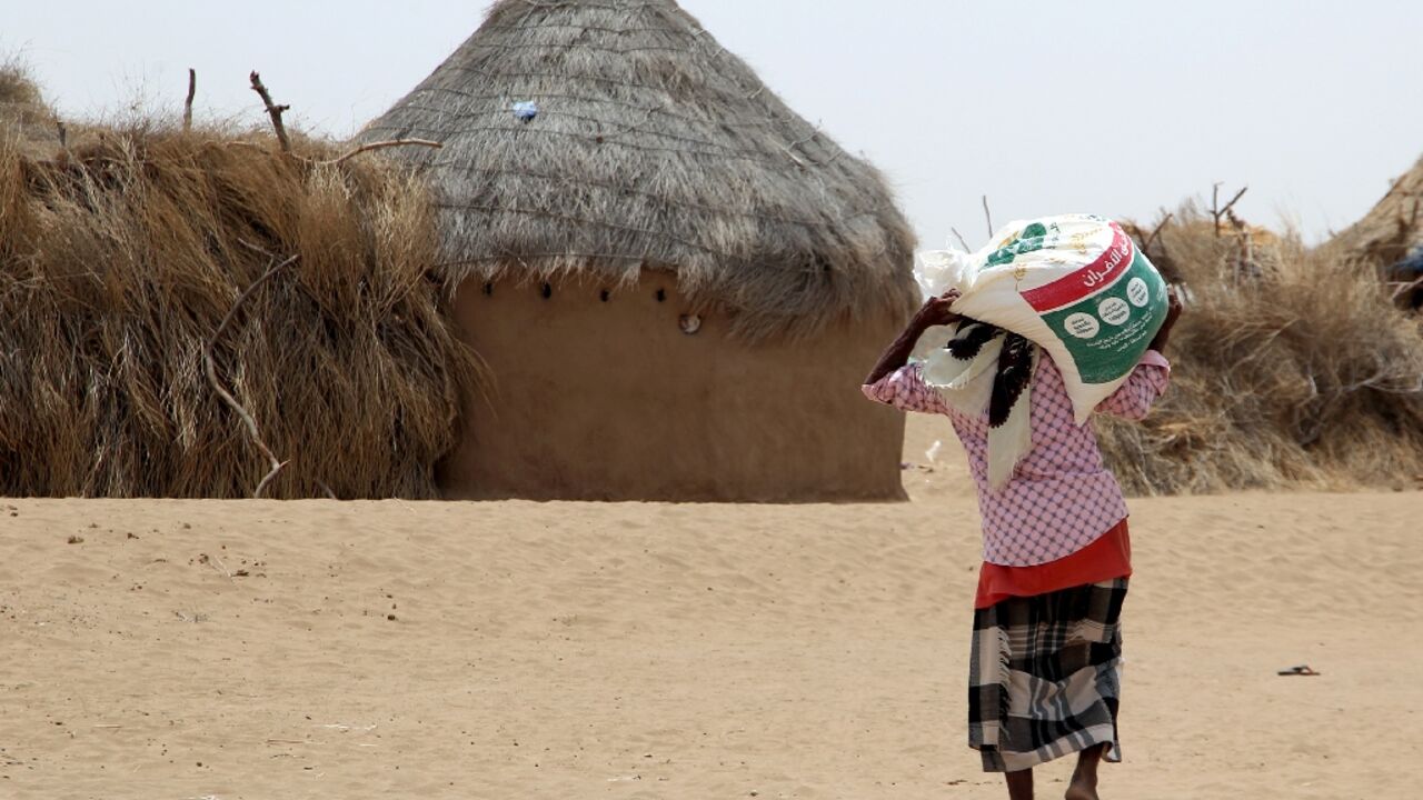 The Yemen war has displaced millions, including this resident receiving food aid at a camp in Hodeida province