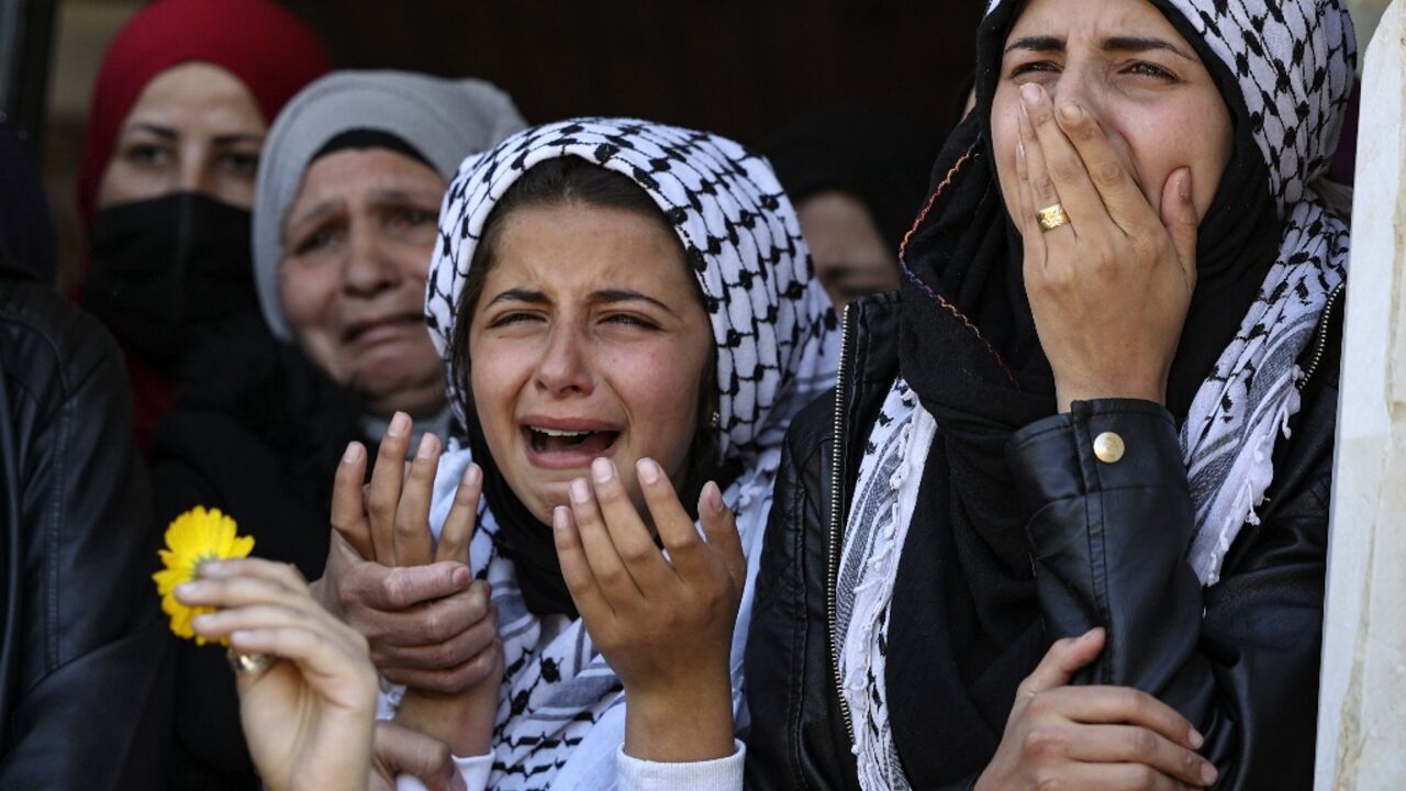 Mourners react during the funeral of a Palestinian shot during  clashes with Israeli troops in Silwad, north of the occupied West Bank city of Ramallah, on April 14, 2022