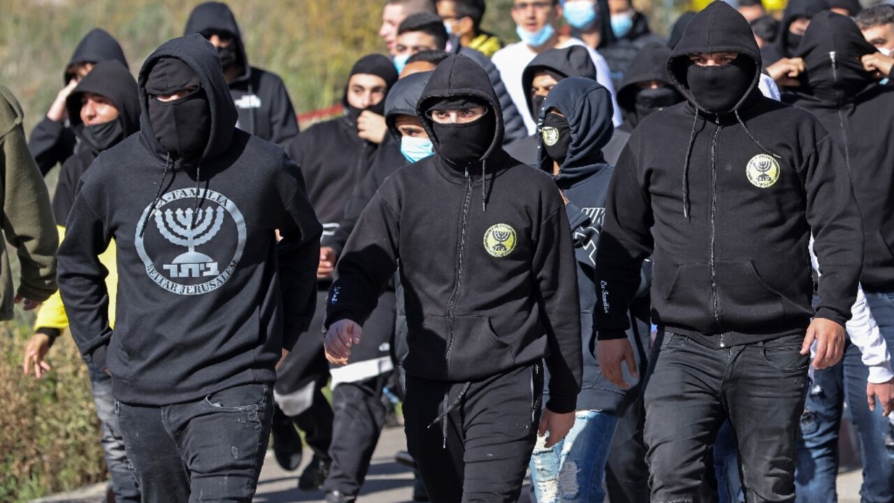 Members of "La Familia", a far-right fan group of Israel's Beitar Jerusalem football club, arrive on December 11, 2020 to confront supporters of the purchase, by a member of Abu Dhabi's royal family, of half ownership in the club Members of "La Familia", a far-right fan group of Israel's Beitar Jerusalem football club, arrive on December 11, 2020 to confront supporters of the purchase, by a member of Abu Dhabi's royal family, of half ownership in the club