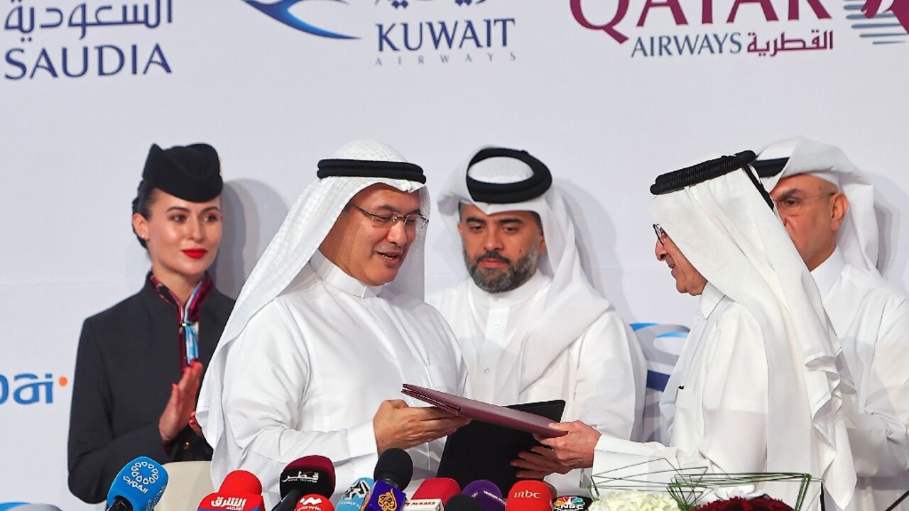 Facing growing pressure to cope with the World Cup football tournament, Qatar Airways chief executive Akbar Al Baker (R) said the national airline would halt some routes to countries not participating during the tournament