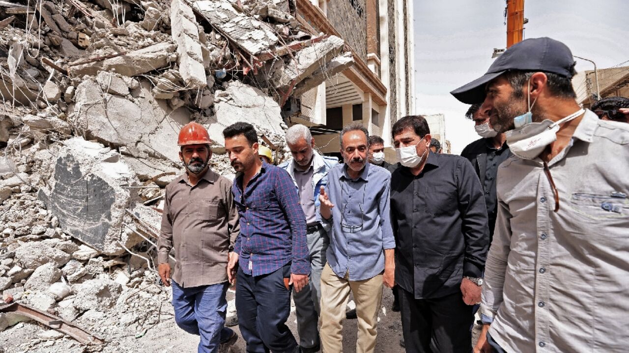 Iranian Vice President Mohammad Mokhber (2nd-R), shown visiting the site of the collapsed building, said there had been "widespread corruption"