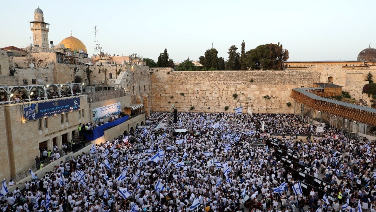 Thousands of flag-waving Israelis marched into the Muslim quarter of Jerusalem's Old City during a nationalist procession that culminated at the Western Wall below the Al-Aqsa mosque