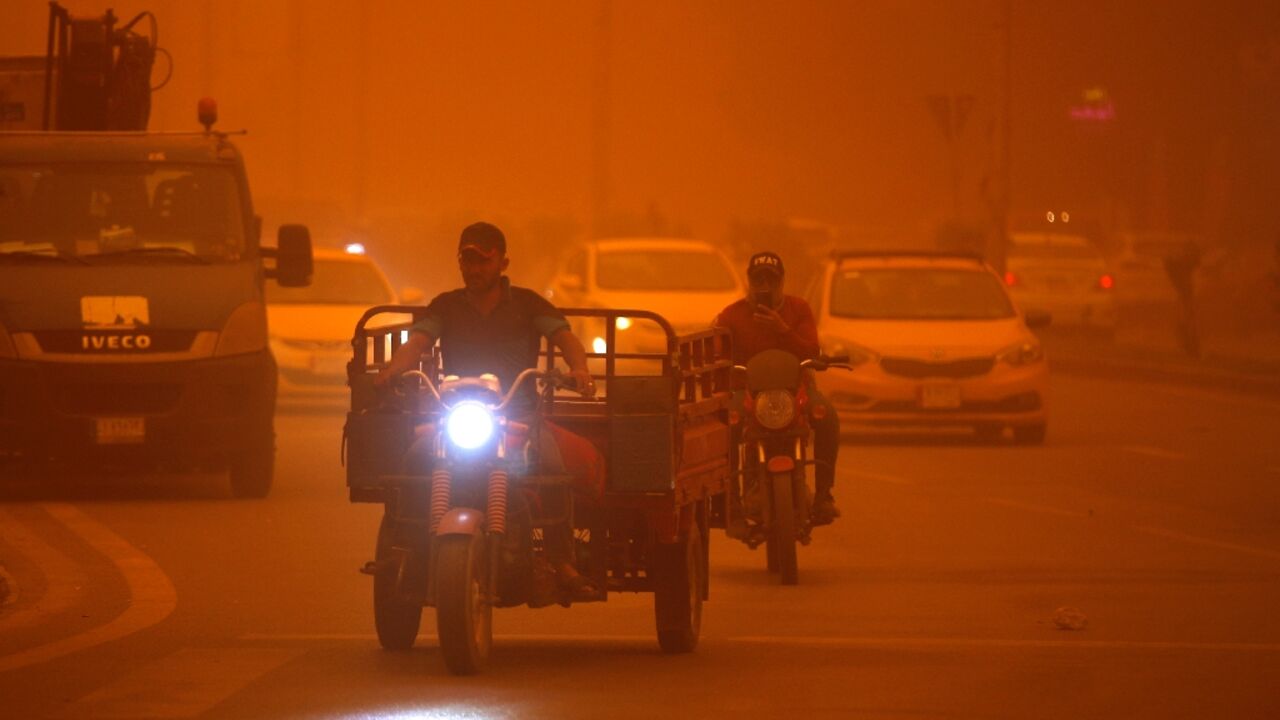 Vehicles drive along a road during a severe dust storm in Iraq's capital Baghdad Vehicles drive along a road during a severe dust storm in Iraq's capital Baghdad