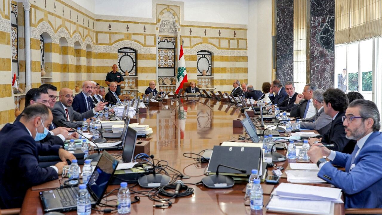 Lebanon's President Michel Aoun (C-R) and Prime Minister Najib Mikati (C-L) headed the outgoing government's final cabinet meeting at the governmental palace in the capital Beirut