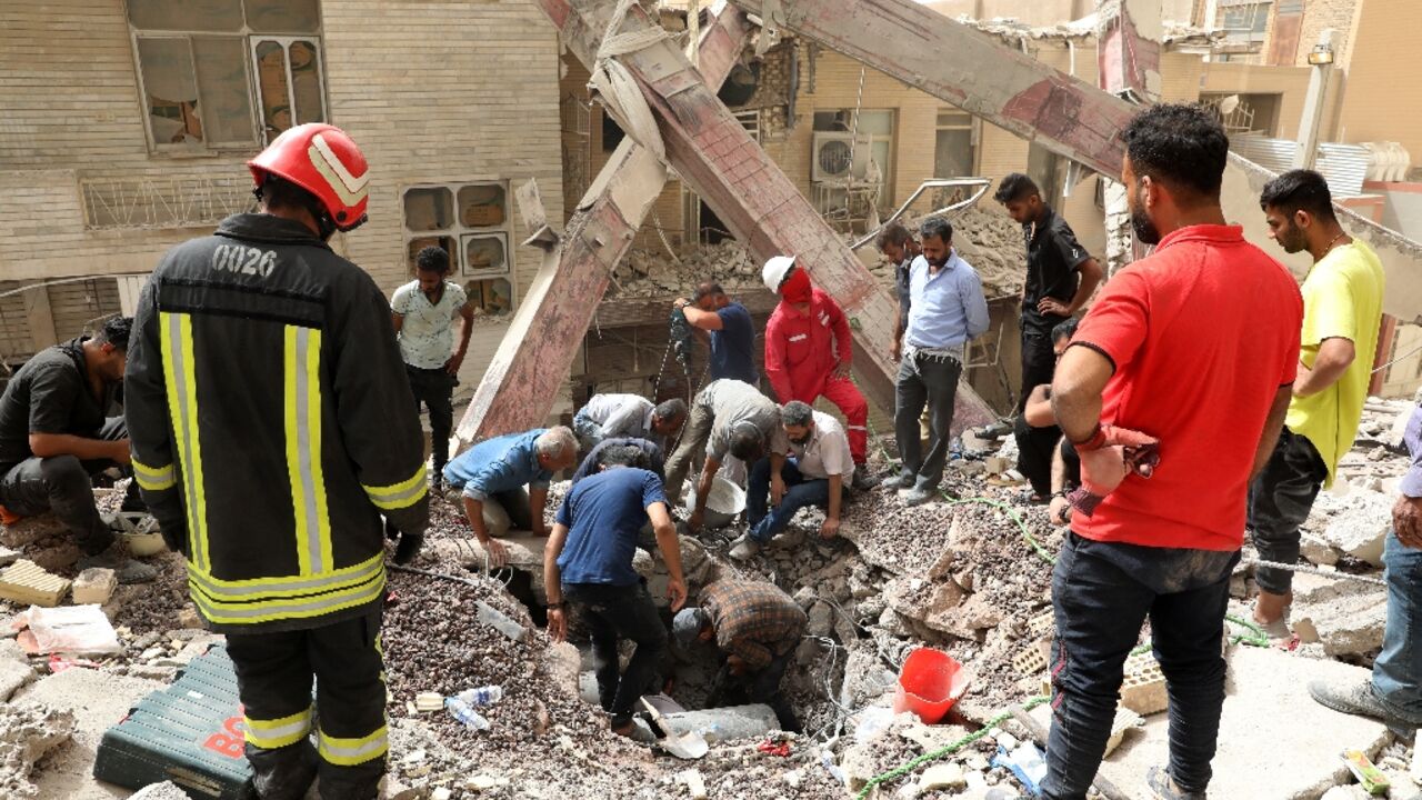 Iranian rescuers search the rubble of a 10-storey building that collapsed in the southwestern city of Abadan 