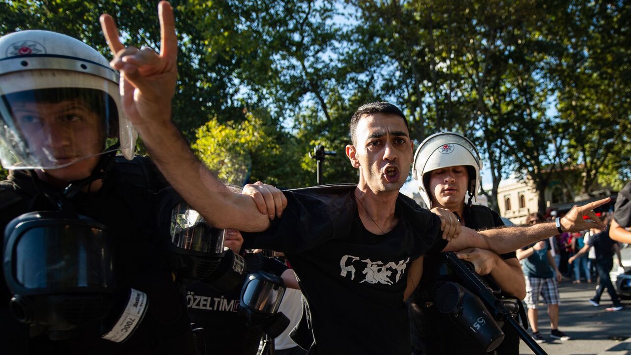 Turkish police try to arrest an ultranationalist protester.