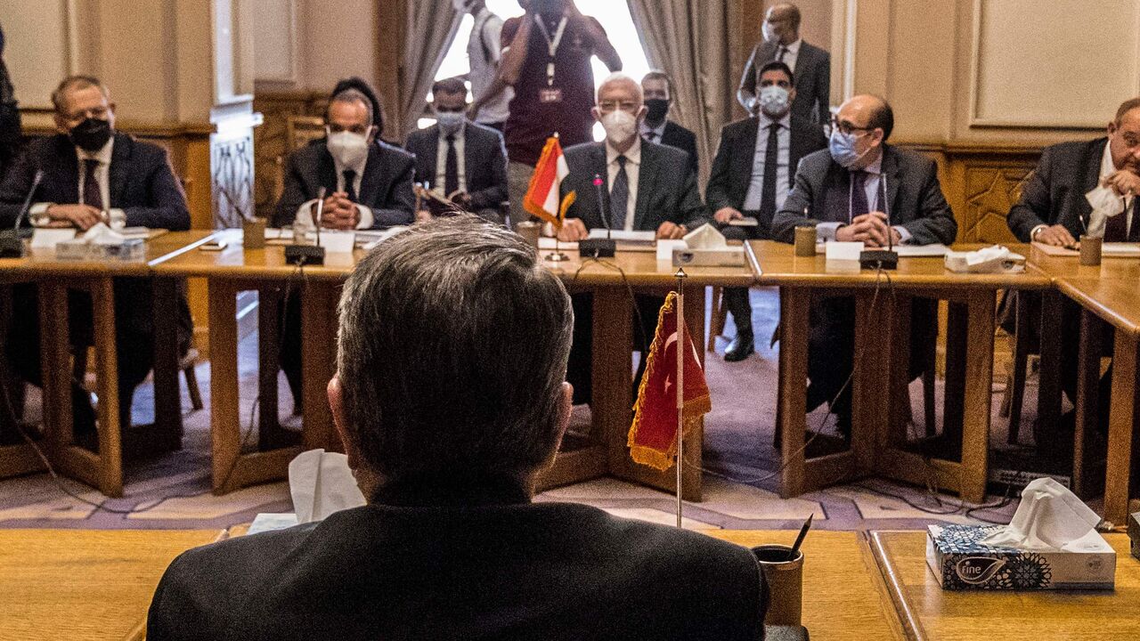 Egypt's Deputy Foreign Minister Hamdi Sanad Loza (background) meets with his Turkish counterpart Sedat Onal (Foreground).