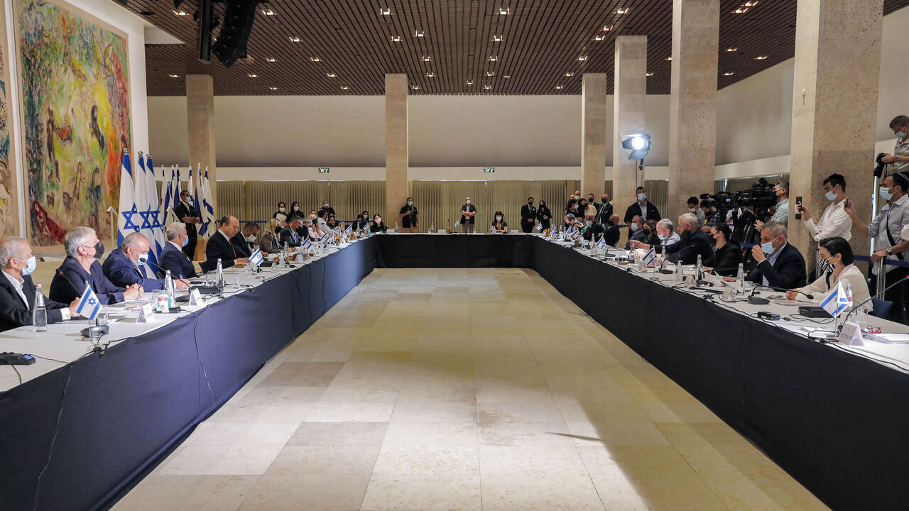 Israeli government ministers look on as Prime Minister Naftali Bennett chairs the weekly Cabinet meeting at Chagall State Hall in the Knesset building, Jerusalem, July 19, 2021.