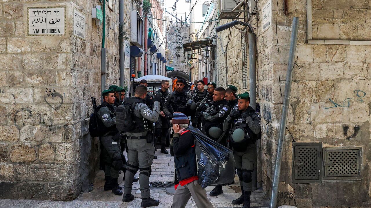 Israeli border police members gather by the Via Dolorosa in the old city of Jerusalem on March 28, 2022.