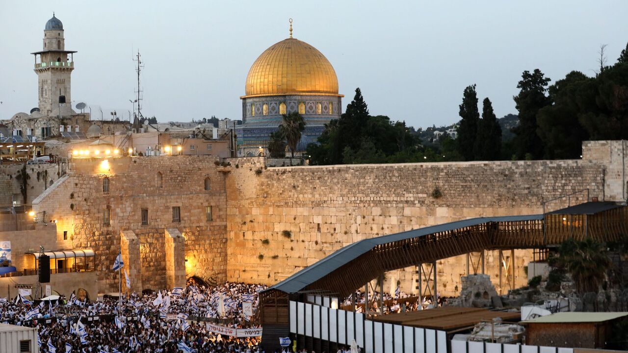 Demonstrators gather with Israeli flags at the Western Wall in the old city of Jerusalem on May 29, 2022, during the Israeli 'flags march' to mark "Jerusalem Day". 