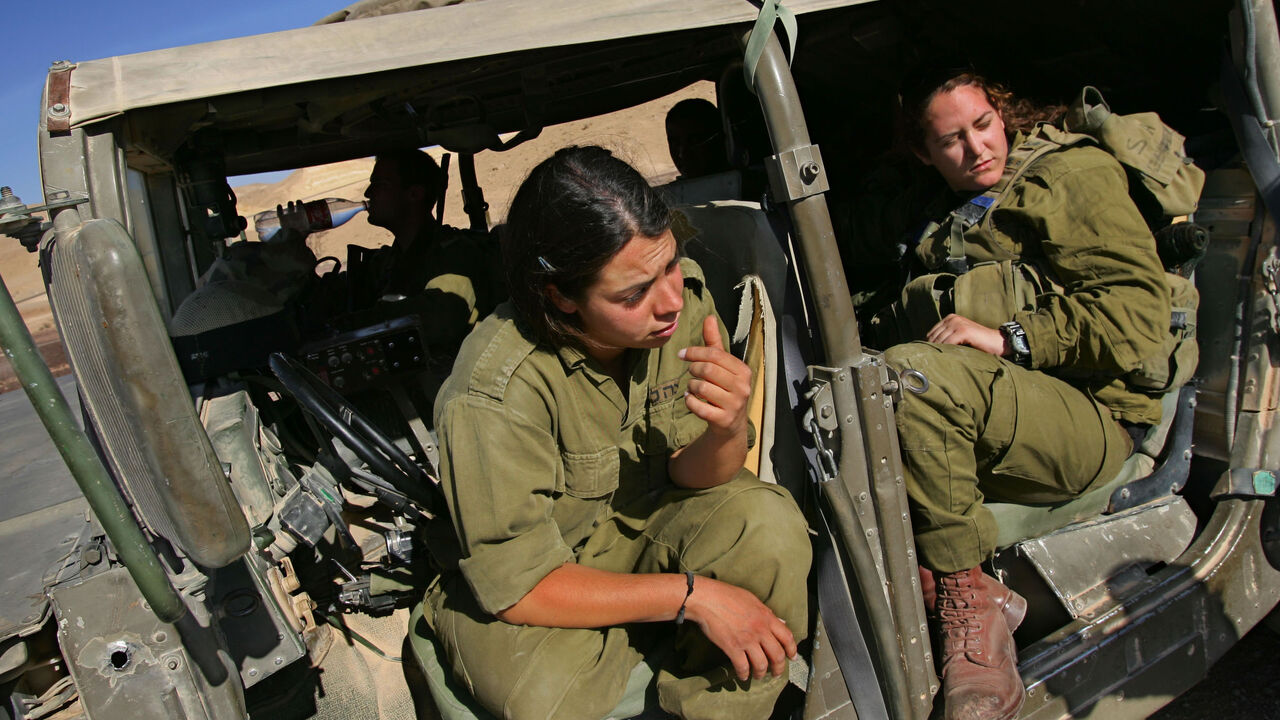 Female soldiers from the Israeli army's Caracal battalion take a break in their Hummer between patrols on June 12, 2007.