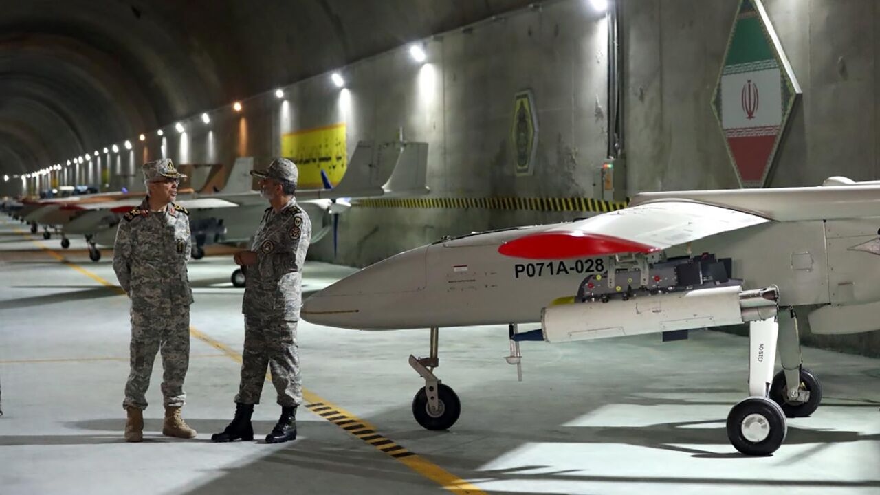 A handout picture provided by the Iranian army shows Iranian Army Major General Abdolrahim Mousavi and Armed Forces Chief of Staff Major General Mohammad Bagheri visiting the underground drone base