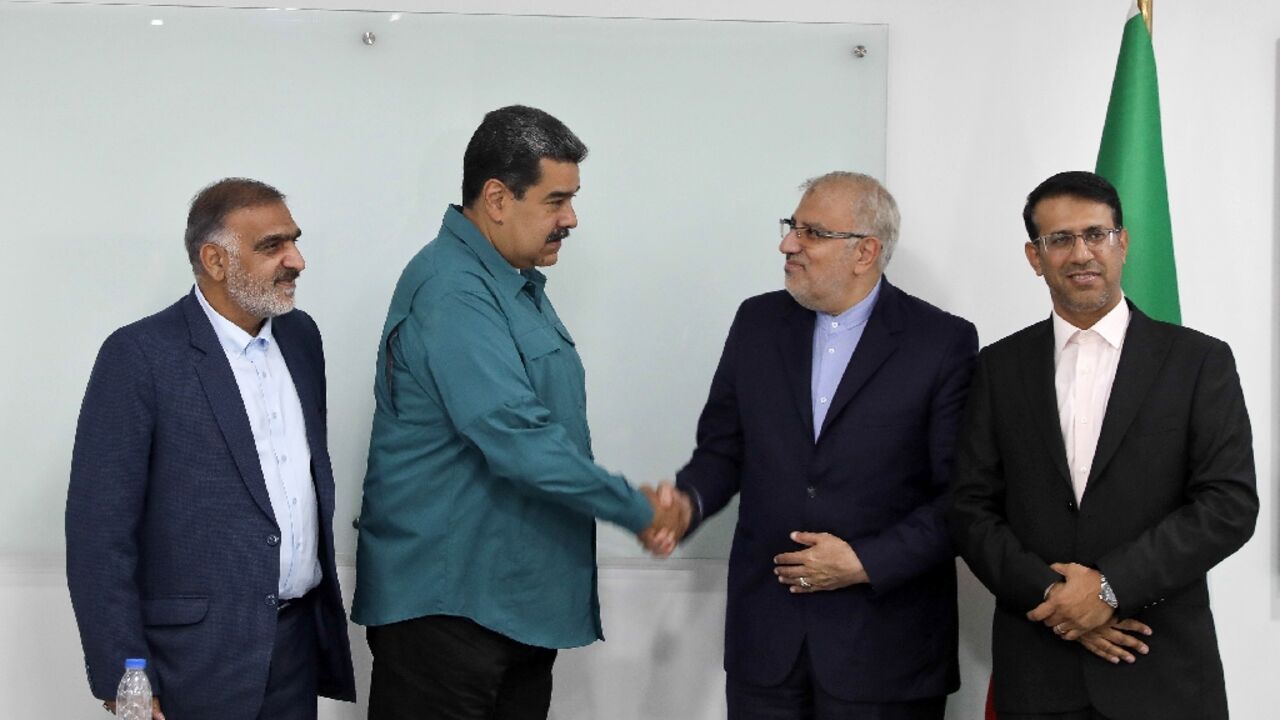Handout picture released by the Venezuelan Presidency showing President Nicolas Maduro (2-L) shaking hands with Iran's Oil Minister Javad Owji (2-R) during his visit to Miraflores Presidential Palace for a private meeting in Caracas on May 2, 2022 Handout picture released by the Venezuelan Presidency showing President Nicolas Maduro (2-L) shaking hands with Iran's Oil Minister Javad Owji (2-R) during his visit to Miraflores Presidential Palace for a private meeting in Caracas on May 2, 2022