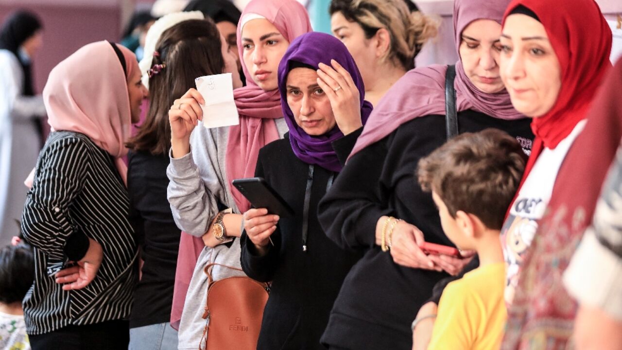 Lebanese women line up to vote for the parliamentary election at a polling station in the capital Beirut's southern suburbs, on May 15, 2022 Lebanese women line up to vote for the parliamentary election at a polling station in the capital Beirut's southern suburbs, on May 15, 2022