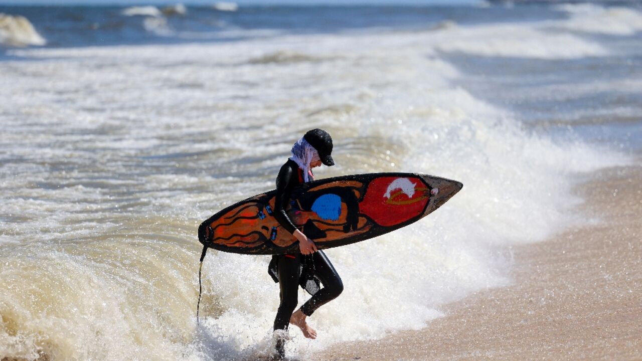 Palestinian surfer Sabah Abu Ghanem emerges from the water at a beach in Gaza City Palestinian surfer Sabah Abu Ghanem emerges from the water at a beach in Gaza City