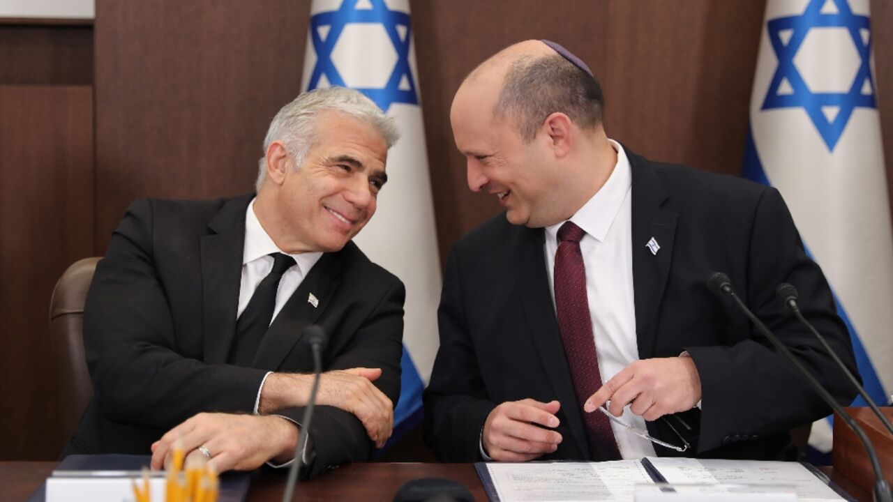 Israeli Prime Minister Naftali Bennett (R) speaks with Foreign Minister Yair Lapid (L) during a cabinet meeting in Jerusalem, Israeli Prime Minister Naftali Bennett (R) speaks with Foreign Minister Yair Lapid (L) during a cabinet meeting in Jerusalem,