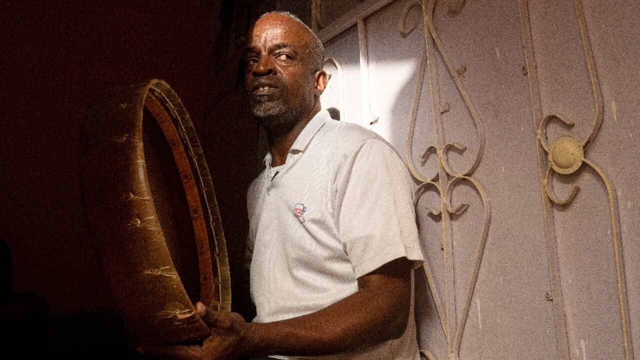 Adnane Abdelrahmane, 56, beats a hand drum at his home in Iraq's southern city of Zubair 