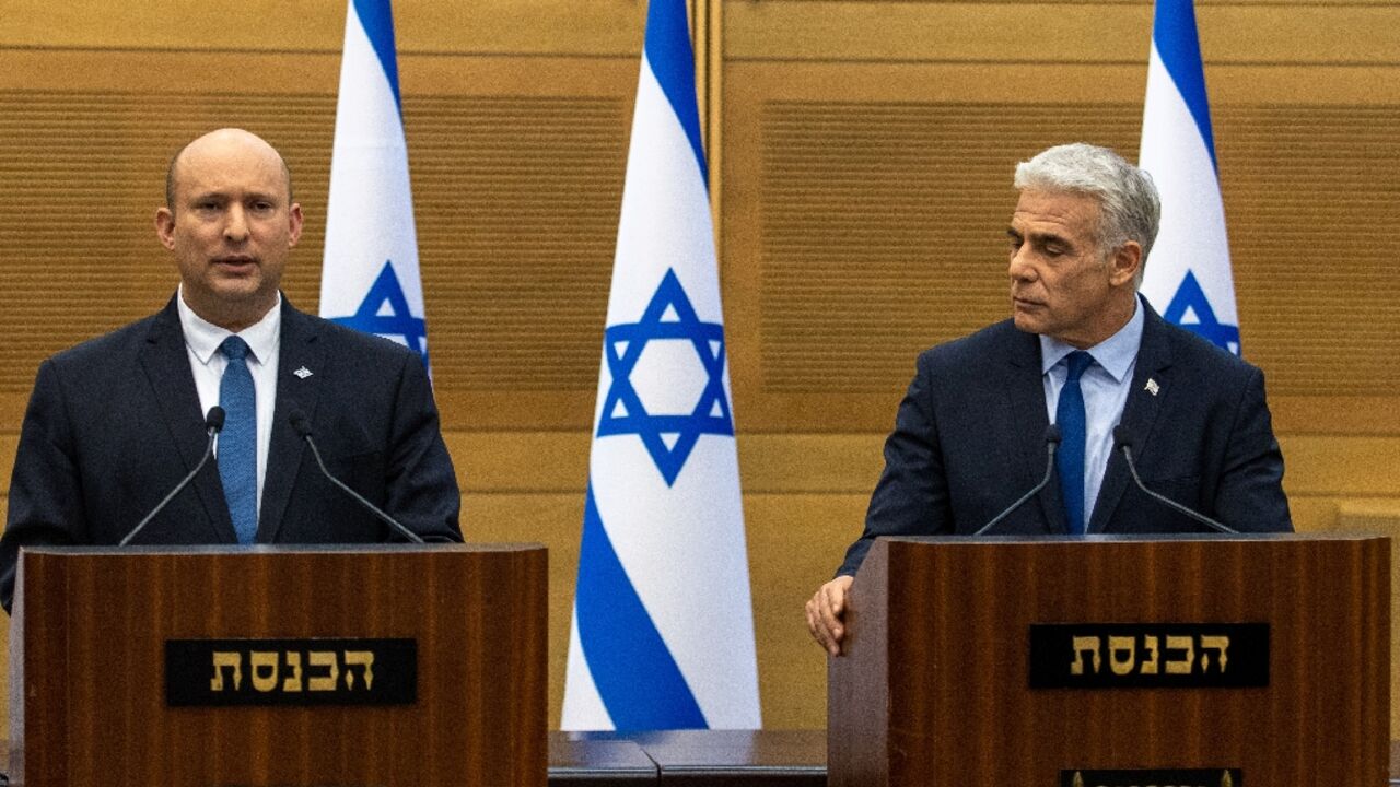 Israel's Prime Minister Naftali Bennett (L) and Foreign Minister Yair Lapid make a joint statement to the press in Jerusalem