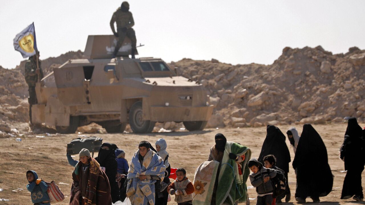 Civilians fleeing the battered Islamic State-held holdout of Baghouz.