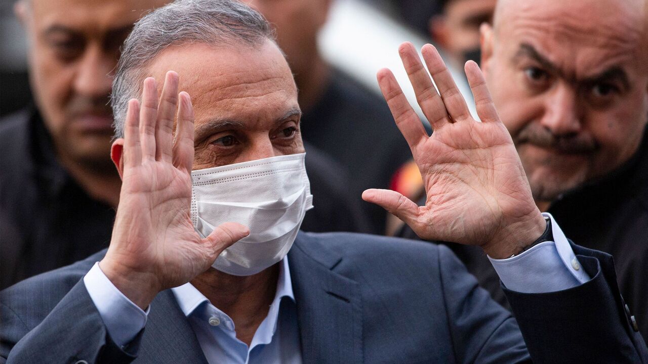 Iraq's Prime Minister Mustafa Kadhimi arrives to attend a memorial service for the victims of a motorcycle bomb that exploded the day before, in the southern city of Basra on Dec. 8, 2021. 