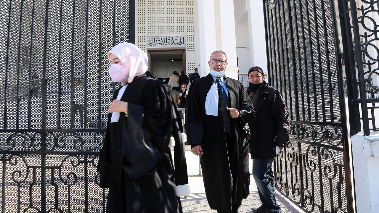 Tunisian citizens and lawyers leave the court of the governorate of Ariana after the announcement of a strike by judges, following the dissolution of the Supreme Council of the Judiciary by President Kais Saied, Feb. 9, 2022.