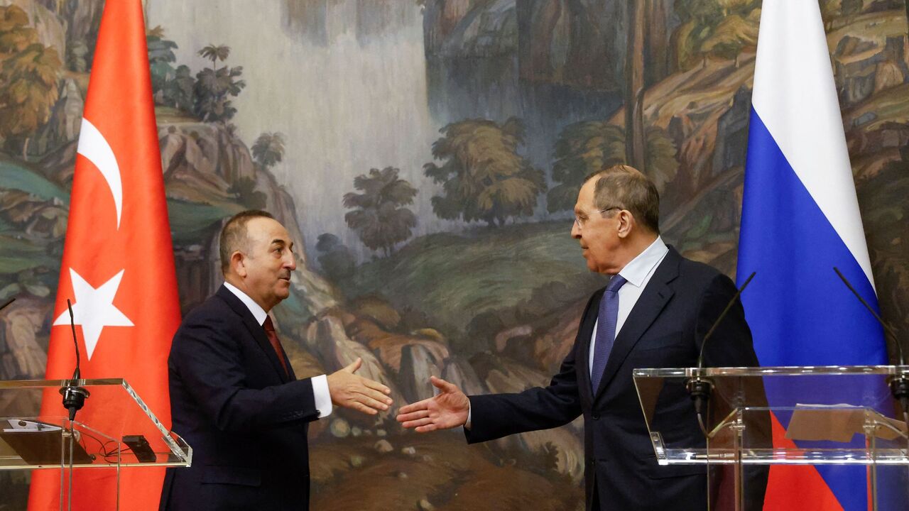 Russian Foreign Minister Sergei Lavrov and his Turkish counterpart Mevlut Cavusoglu shake hands during a joint press conference following their talks in Moscow on March 16, 2022. 